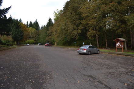 Paved parking lot has access to trails, picnic shelter, accessible restrooms and off leash dog park